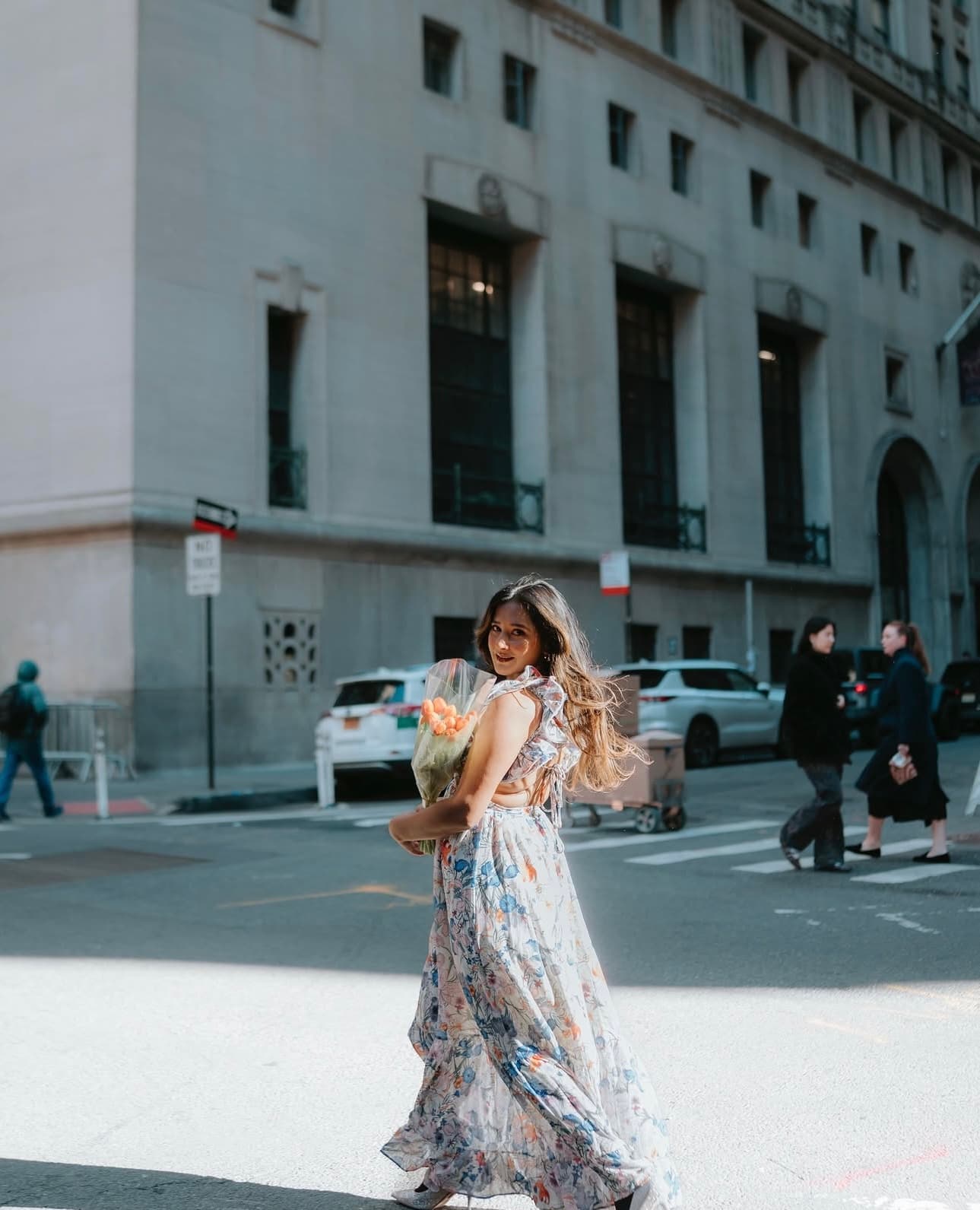 Maitreyi Tiwari walking in a floral dress on a New York street